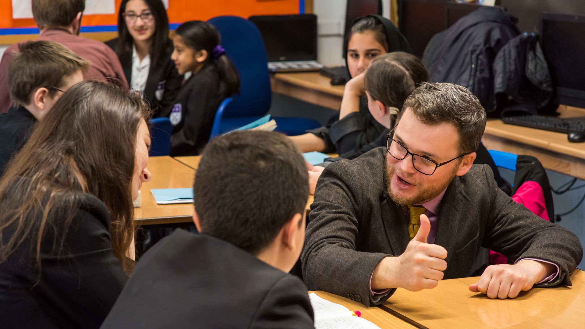 Teacher talking to pupils